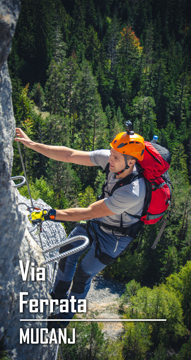 The man is climbing a via ferrata