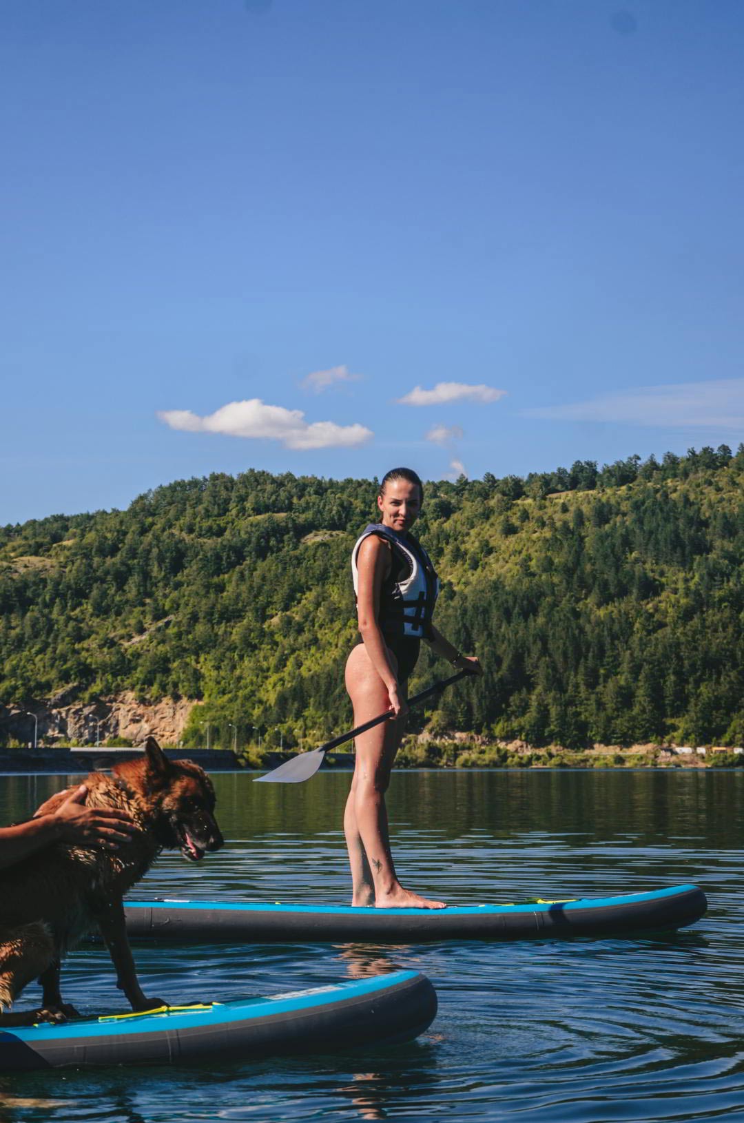 Dog and girl on a paddleboard.