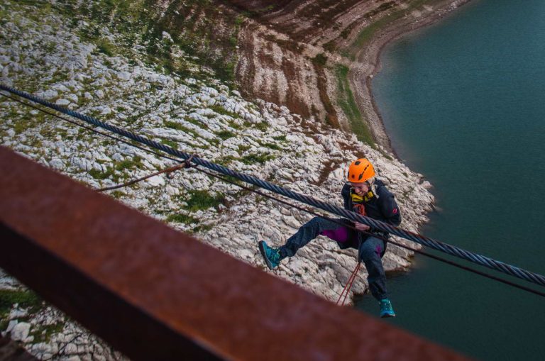 A woman is jumping from the bridge in Puljci above Zlatar Lake.